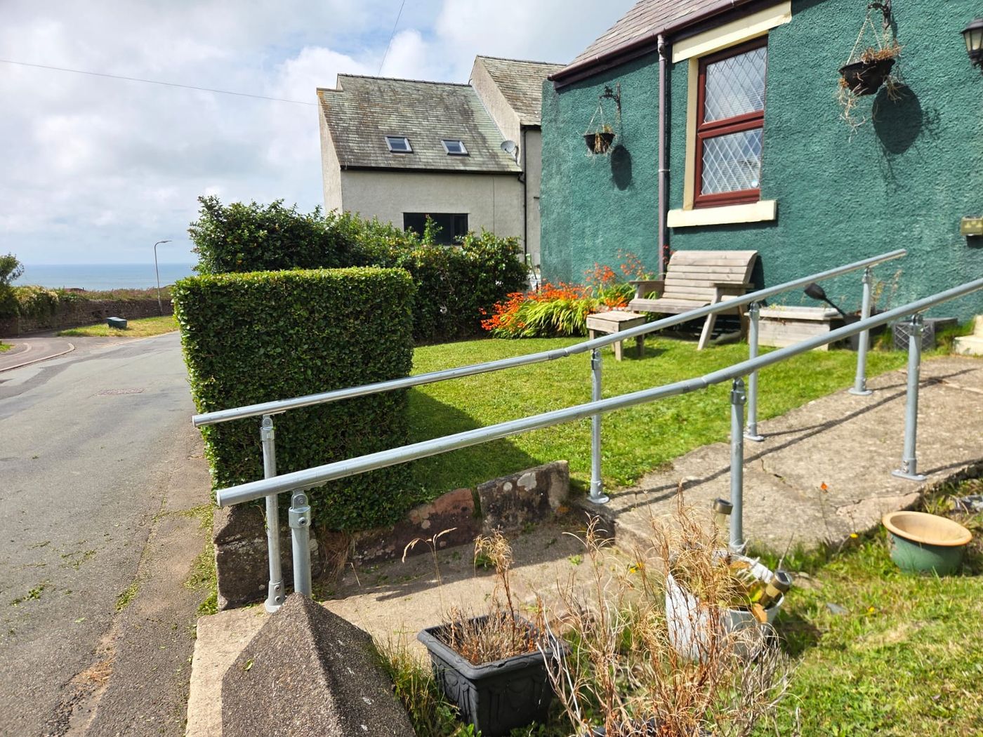 Trimmed lawn and hedges by the coast