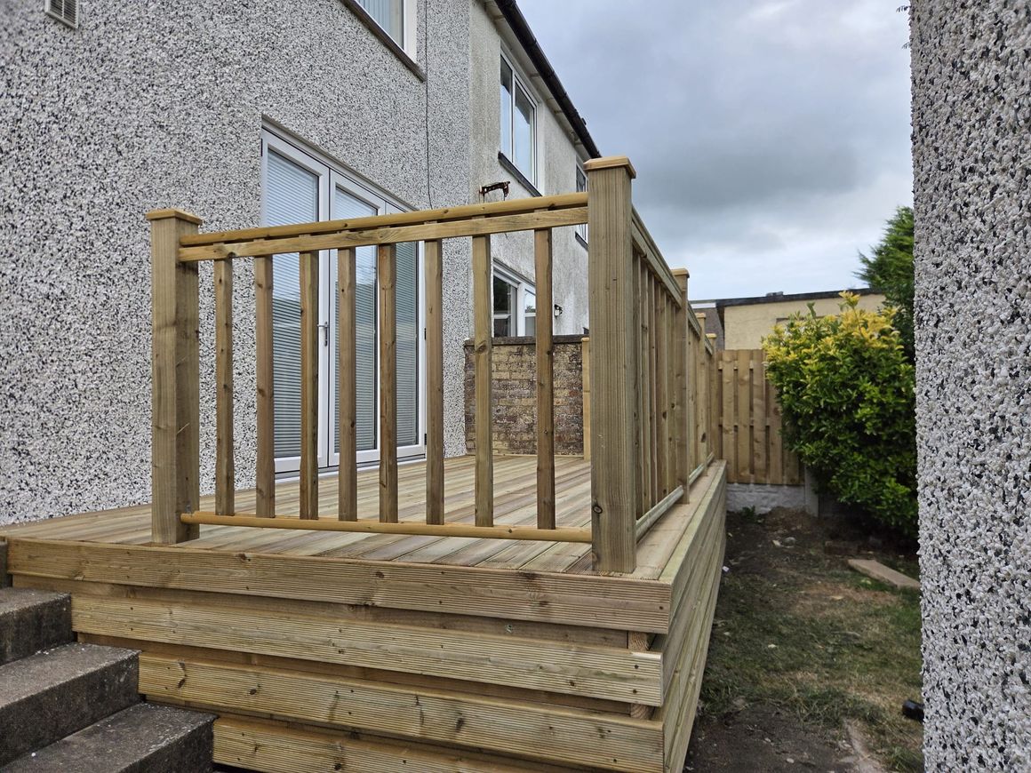 Raised timber deck with a spindle balustrade and steps, West Lakes Fencing, West Cumbria