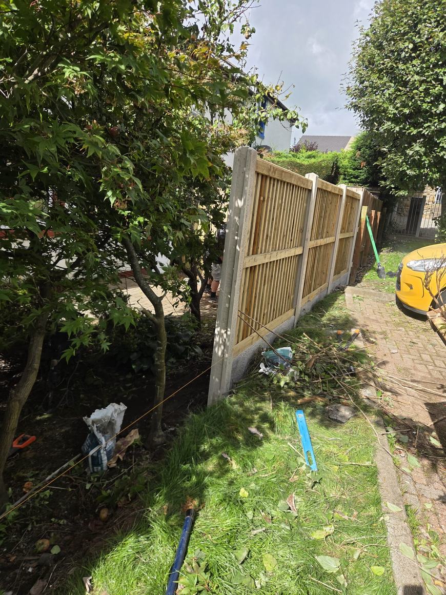 New fence panels going in on concrete posts with a string line set out